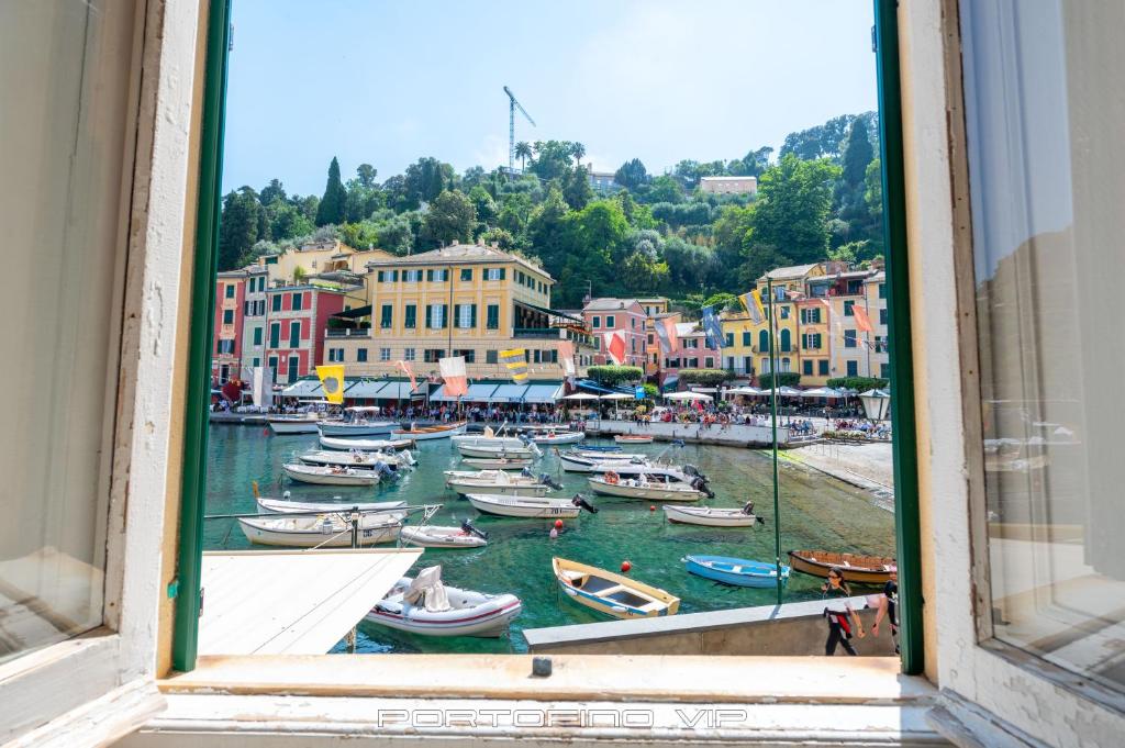 a view from a window of boats in a harbor at Casa Papù 2 by PortofinoVip in Portofino