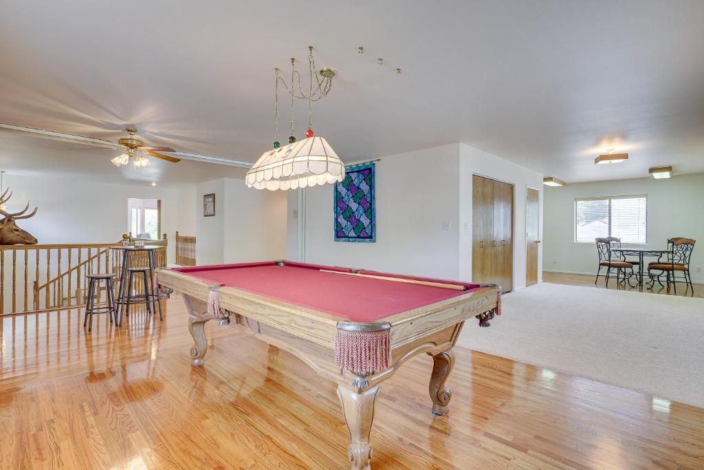a living room with a pool table in it at Charming Elko Home with Pool Table! in Elko