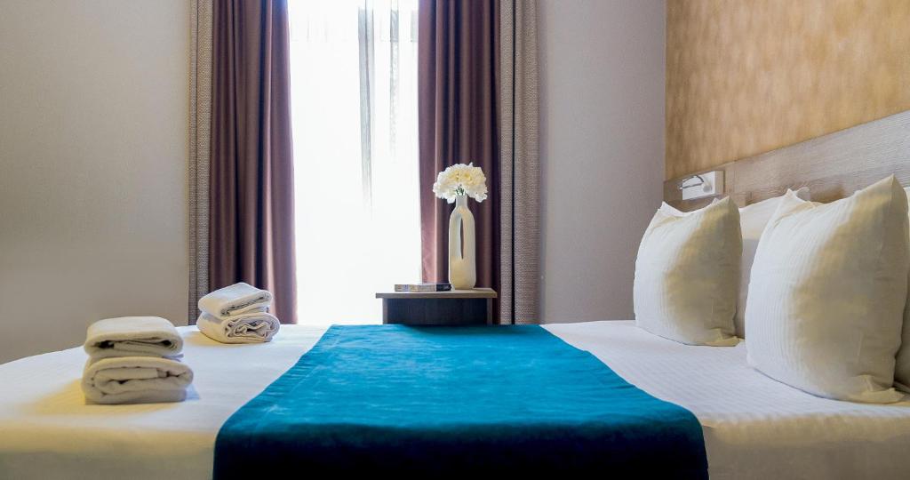 Postel nebo postele na pokoji v ubytování Garni Hotel Mint