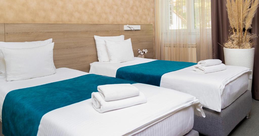 Postel nebo postele na pokoji v ubytování Garni Hotel Mint