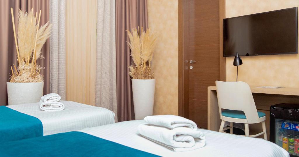 Postel nebo postele na pokoji v ubytování Garni Hotel Mint