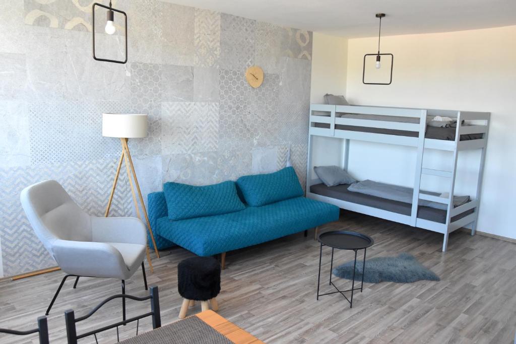 a living room with a couch and a bunk bed at Panorama View Budget Apartment in Veszprém