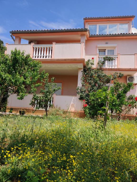 a house on a hill with trees and flowers at Relax to the max with the sea view in Medulin