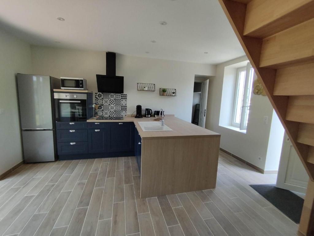 a kitchen with a sink and a stove top oven at Maison de campagne avec terrain in Vallon-en-Sully