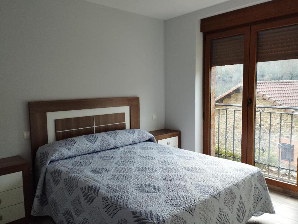 a bedroom with a bed and a large window at Canadina 1 in Morgovejo