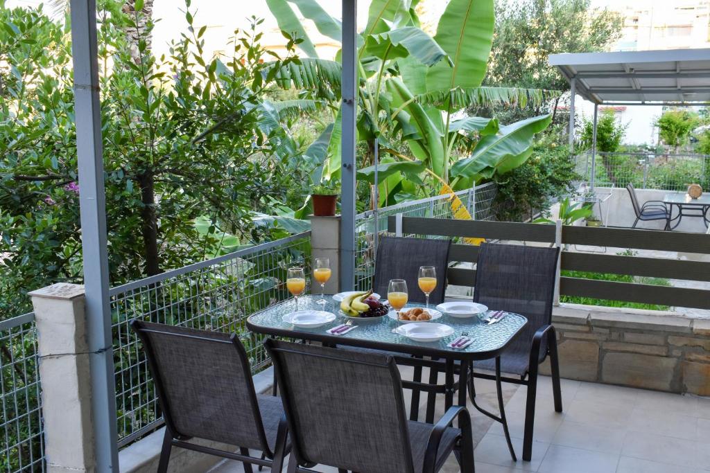 a table with food and drinks on a balcony at Anastasia mare home #A# in Rethymno Town