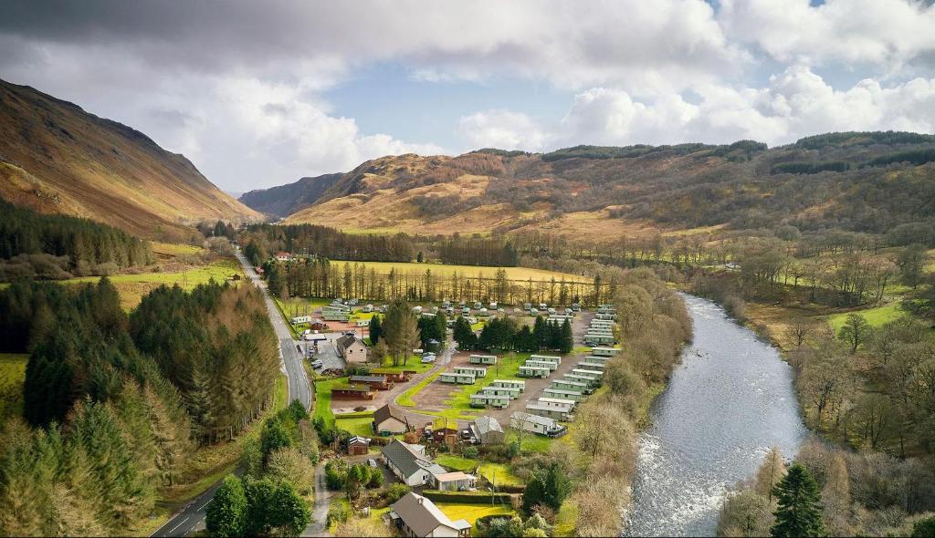 an aerial view of a town next to a river at Loch Awe Holiday Park in Taynuilt