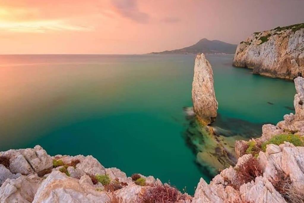 a large rock in the middle of a body of water at Appartamento vista mare Buggerru in Buggerru
