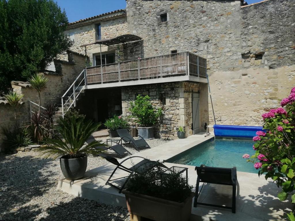 a house with a swimming pool and a building at Maison de village ancienne poste in Bourdic