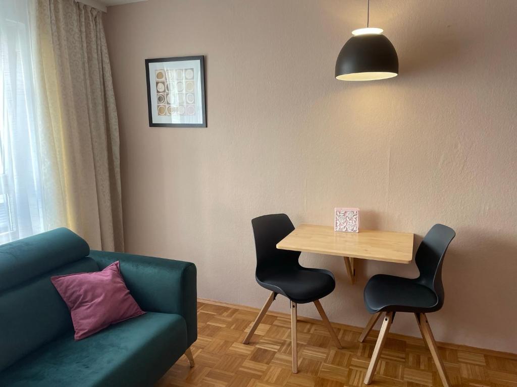 a living room with a couch and a table and chairs at Ferienwohnung Stadtmitte Würzburg in Würzburg