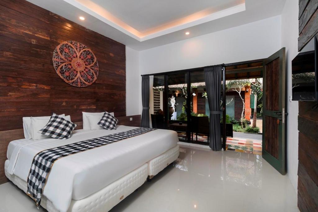 Postel nebo postele na pokoji v ubytování Nawa Sakti Ubud Suite