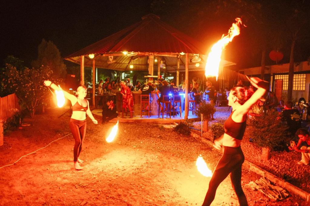 two women are performing a performance with fire torches at Escape Divers - The Jungle in Koh Tao