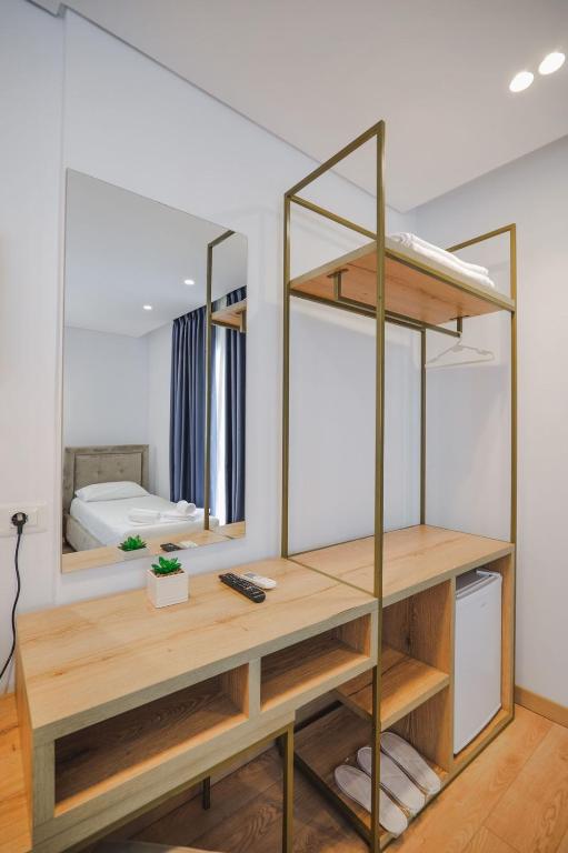 a dressing room with a desk and mirror at Otto Hotel in Ksamil