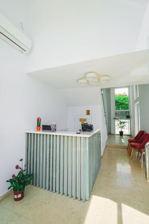 a living room with a bar in the middle of a room at Otto Hotel in Ksamil