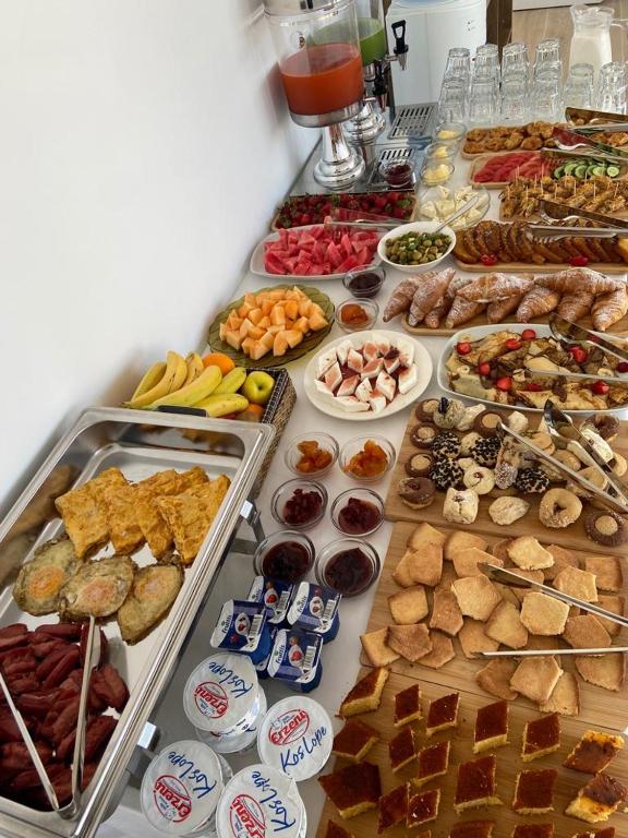 a table filled with lots of different types of food at Otto Hotel in Ksamil