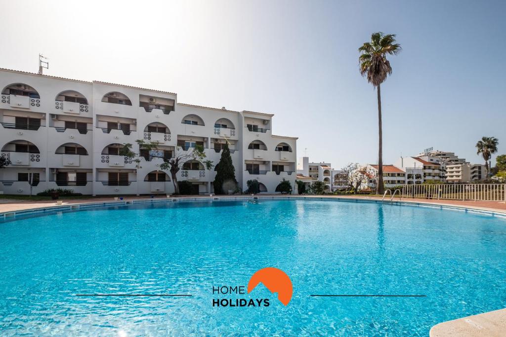 a large swimming pool in front of a building at #079 T1 Vale Mangude by Home Holidays in Vale de Pedras