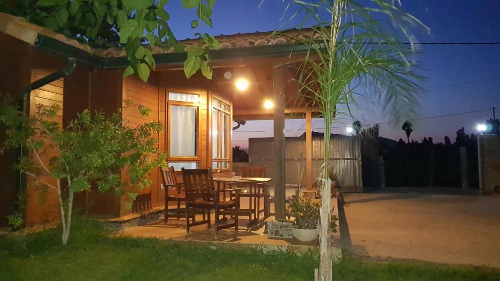 a house with a table and chairs on a patio at LA TRAMUNTANA CULLERA Playa Marenyet a 300 metros in Valencia