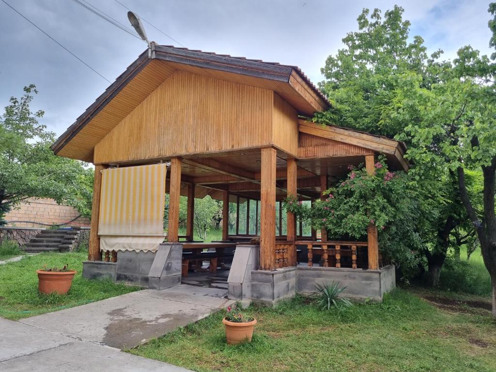 a small wooden house in a yard with trees at Star Apartment in Ashtarak, Mughni in Ashtarak