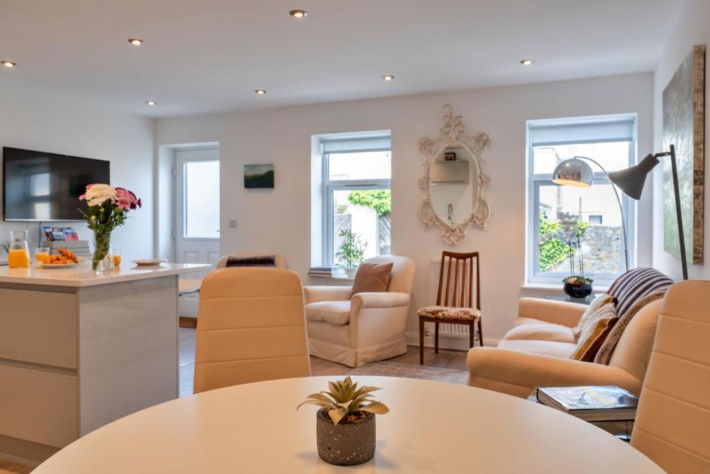 a living room with a table and chairs at Finest Retreats - Brunels Reach in Saltash