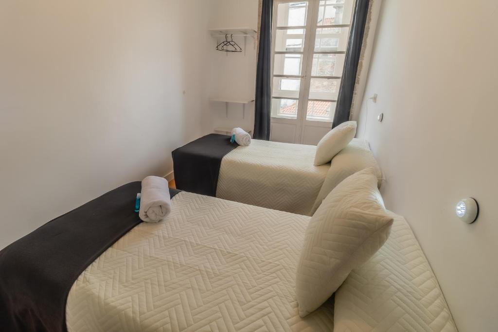 Posteľ alebo postele v izbe v ubytovaní Hostal San Pelayo