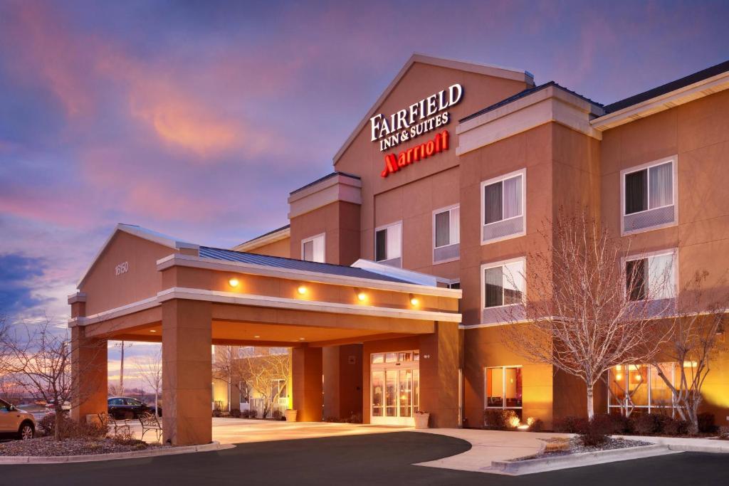 a hotel with a sign on the front of a building at Fairfield Inn & Suites Boise Nampa in Nampa