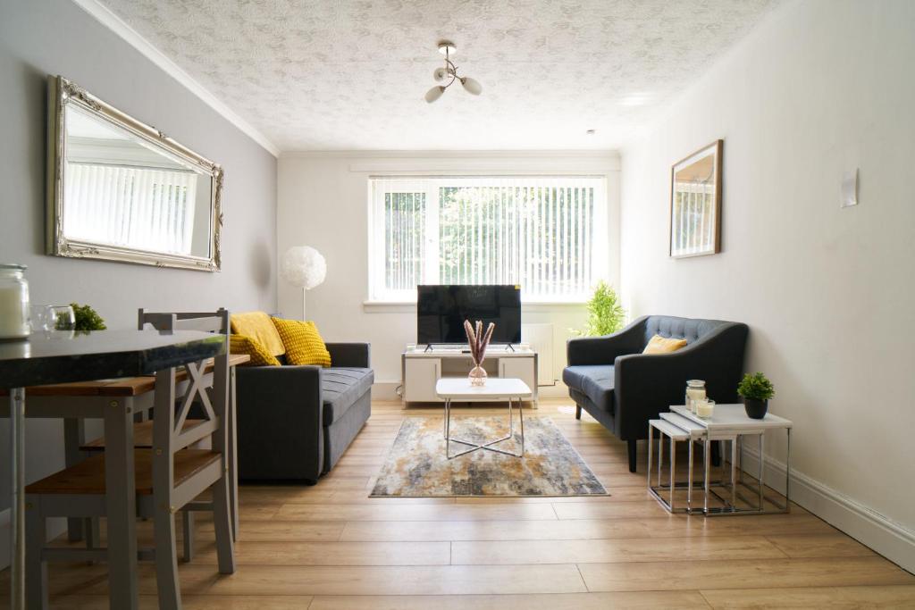 a living room with a couch and a table at Rotherwood Apartment in Glasgow