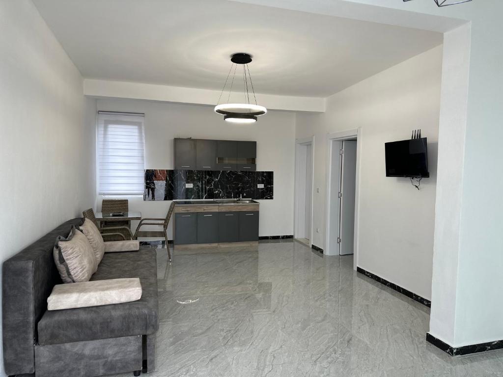 a living room with a couch and a kitchen at Cekaj Palace in Ulcinj