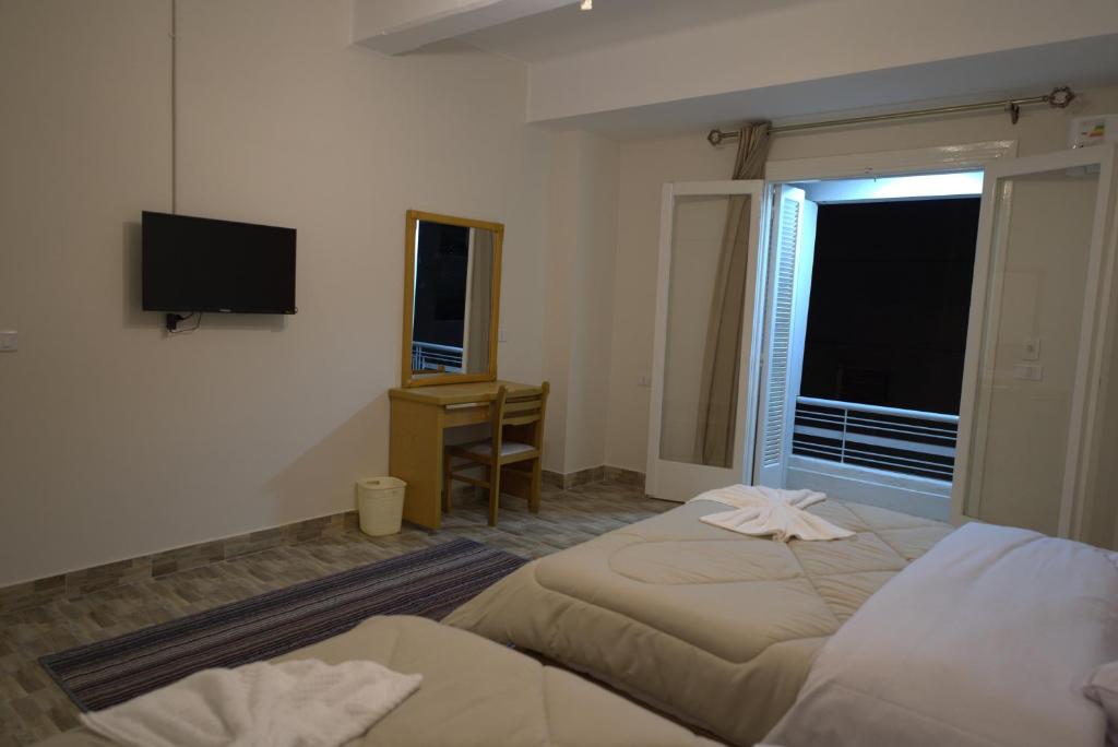 Postel nebo postele na pokoji v ubytování Central Cairo Hotel