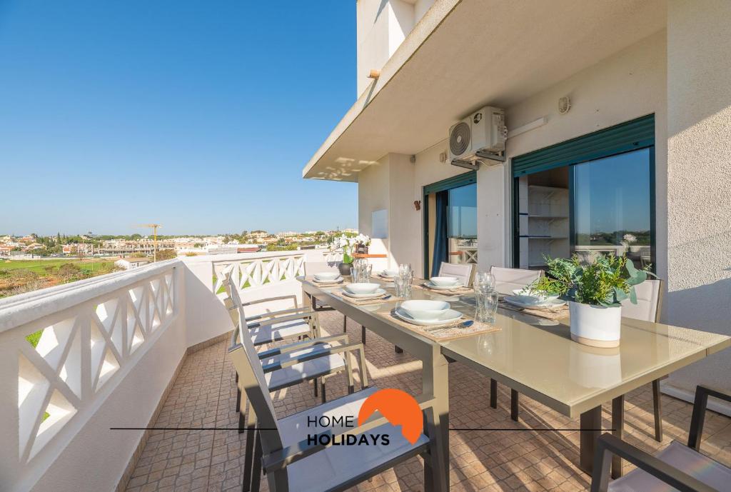 a table on a balcony with a view of the ocean at #071 Maria Luisa by Home Holidays in Albufeira