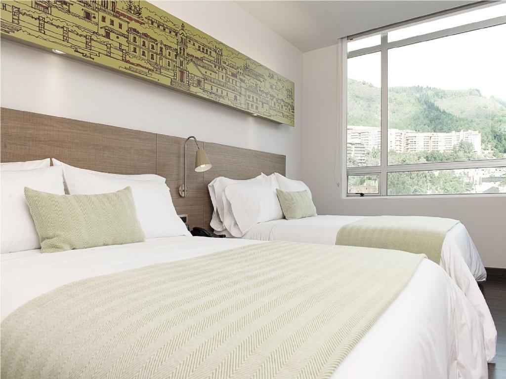 Postel nebo postele na pokoji v ubytování Hotel bh Usaquén