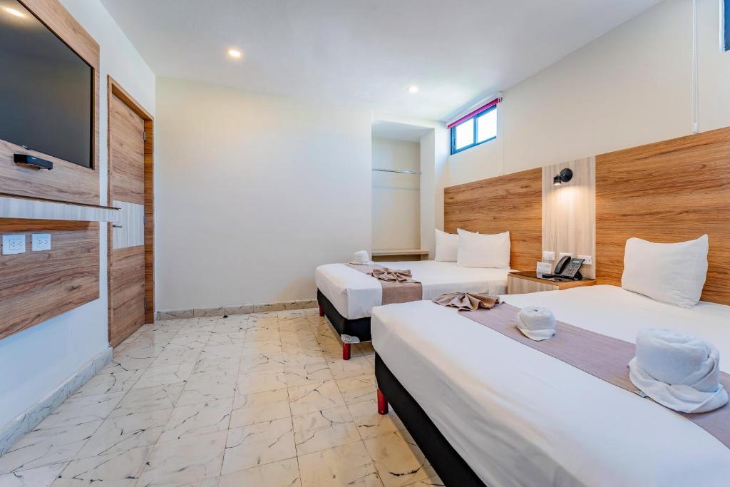 Postel nebo postele na pokoji v ubytování Hotel Central Merida by Kavia