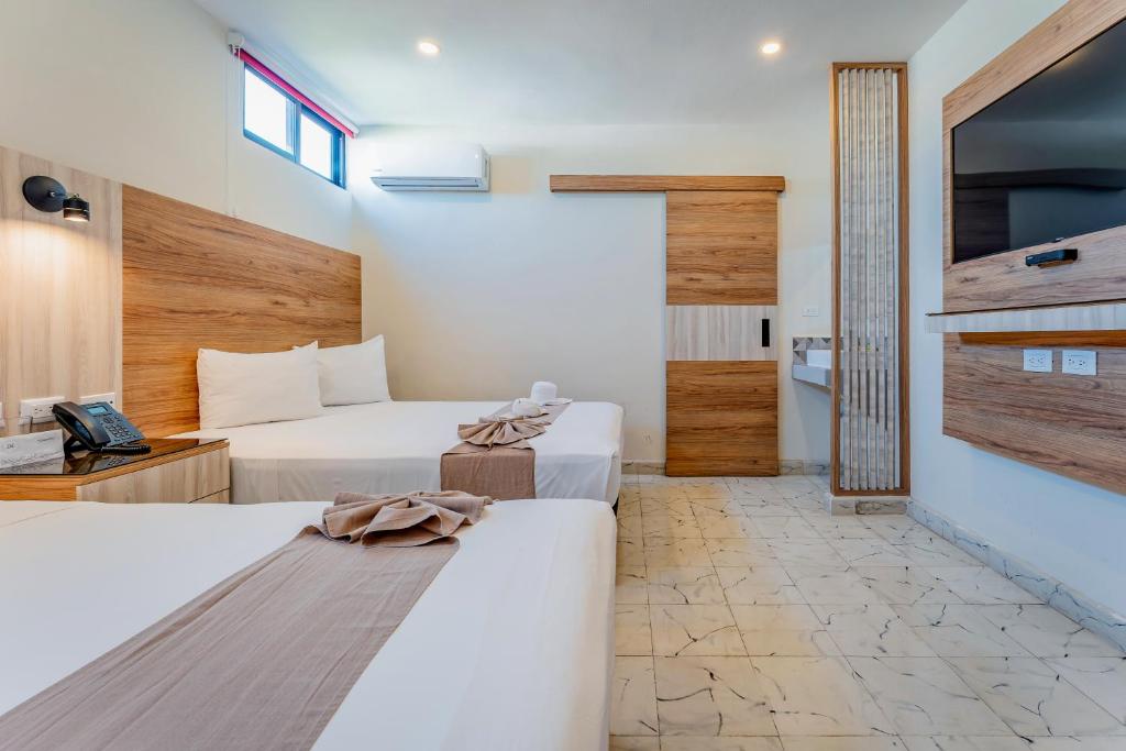 Postel nebo postele na pokoji v ubytování Hotel Central Merida by Kavia