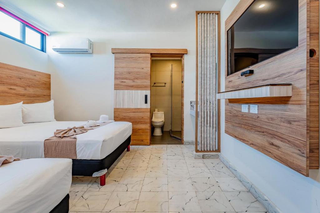 Postel nebo postele na pokoji v ubytování Hotel Central Merida by Kavia
