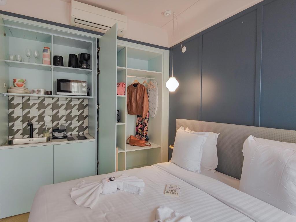 a bedroom with a white bed and a closet at Aparthotel AMMI Nice Lafayette - Reopening 2023 in Nice