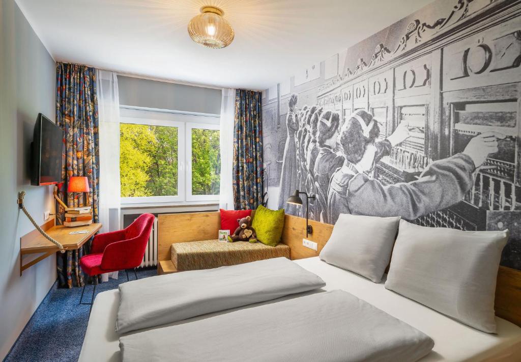 ein Schlafzimmer mit einem Bett und einem Wandbild in der Unterkunft tinyTwice Hotel Bonn in Bonn