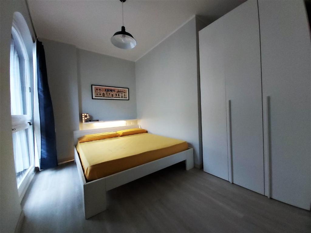a bedroom with a bed and a cabinet at Alba House in Cuneo