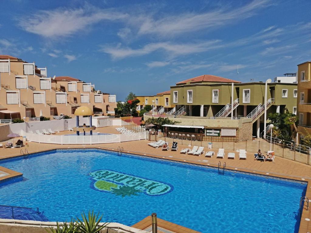 a large swimming pool in front of some buildings at Apartamento Costa Adeje - Orlando Complex in Adeje