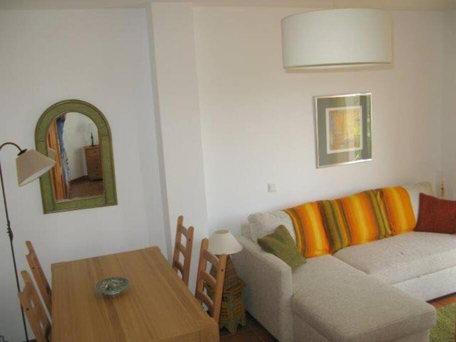 a living room with a couch and a table at La Fuente, apartment in the Moorish quarter. in Frigiliana