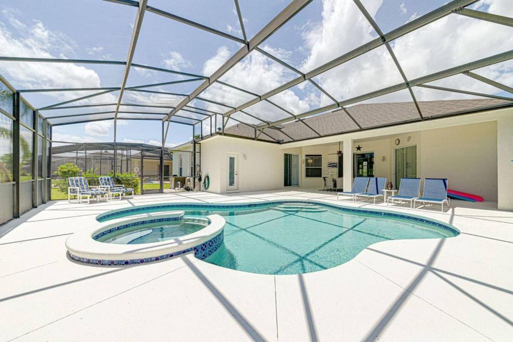 an indoor swimming pool with a glass roof at 596 Modern 5 bed home overlooking beautiful golf course and conservation with Games room in Davenport