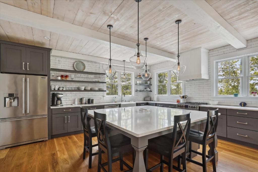 a kitchen with a table and chairs and a refrigerator at Francis Lane in Stowe
