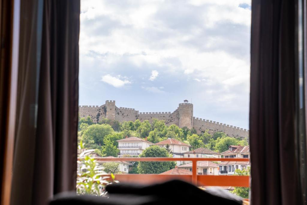 a view of a castle from a window at City Gate Apartment in Ohrid