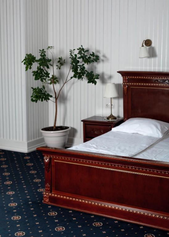 Postel nebo postele na pokoji v ubytování Hotel Aristocrat