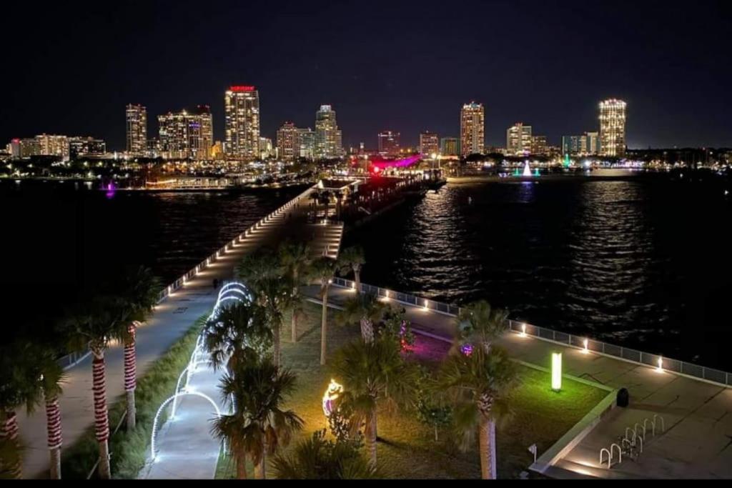 a view of a city at night with the water at Itz a Vibe - 1 bedroom studio in the heart of DTSP in St Petersburg
