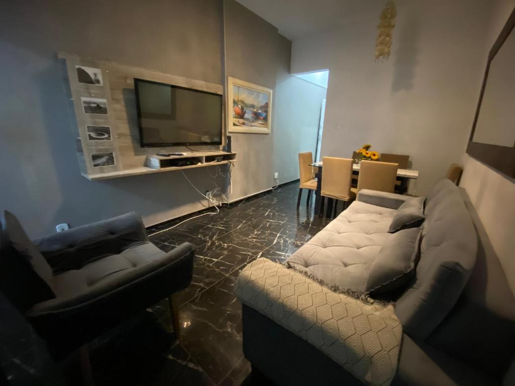 a living room with a couch and a tv at Apartament in Flamengo in Rio de Janeiro