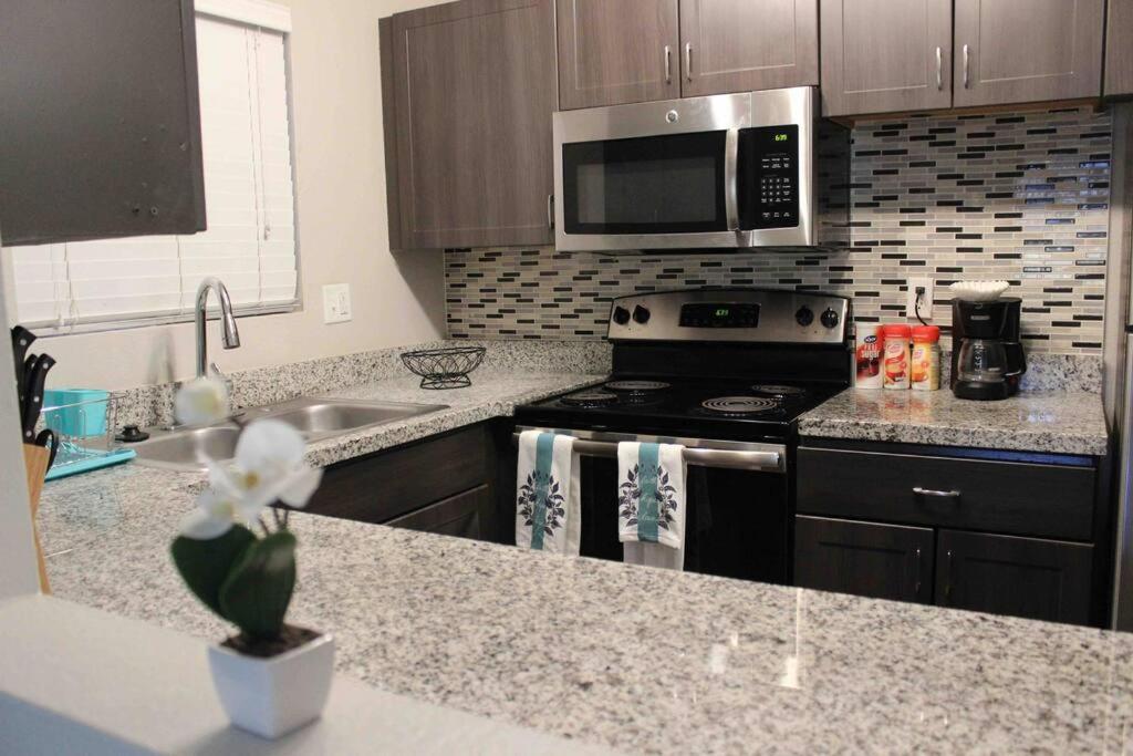 a kitchen with a stove and a microwave at Luxury Tempe Apt by ASU & Airport in Phoenix
