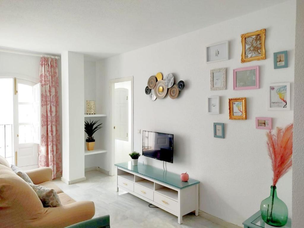 a living room with a tv on a white wall at Embrujo de Mojácar in Mojácar