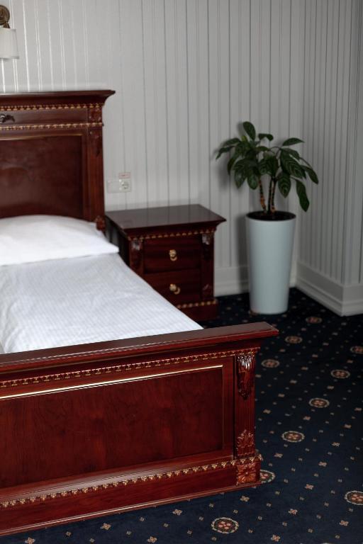 Postel nebo postele na pokoji v ubytování Hotel Aristocrat