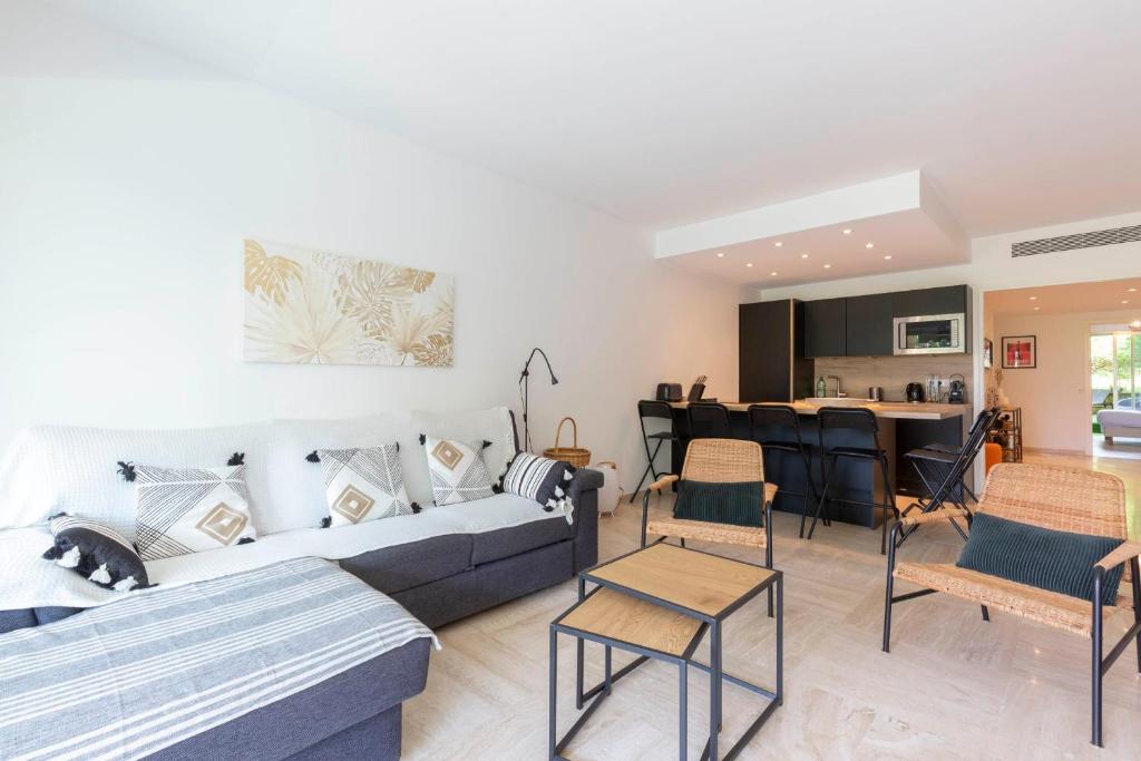 un salon avec un canapé et des chaises et une cuisine dans l'établissement WE CANNES ! Exceptional 4 rooms apartment Cannes Center swimming pool, à Cannes