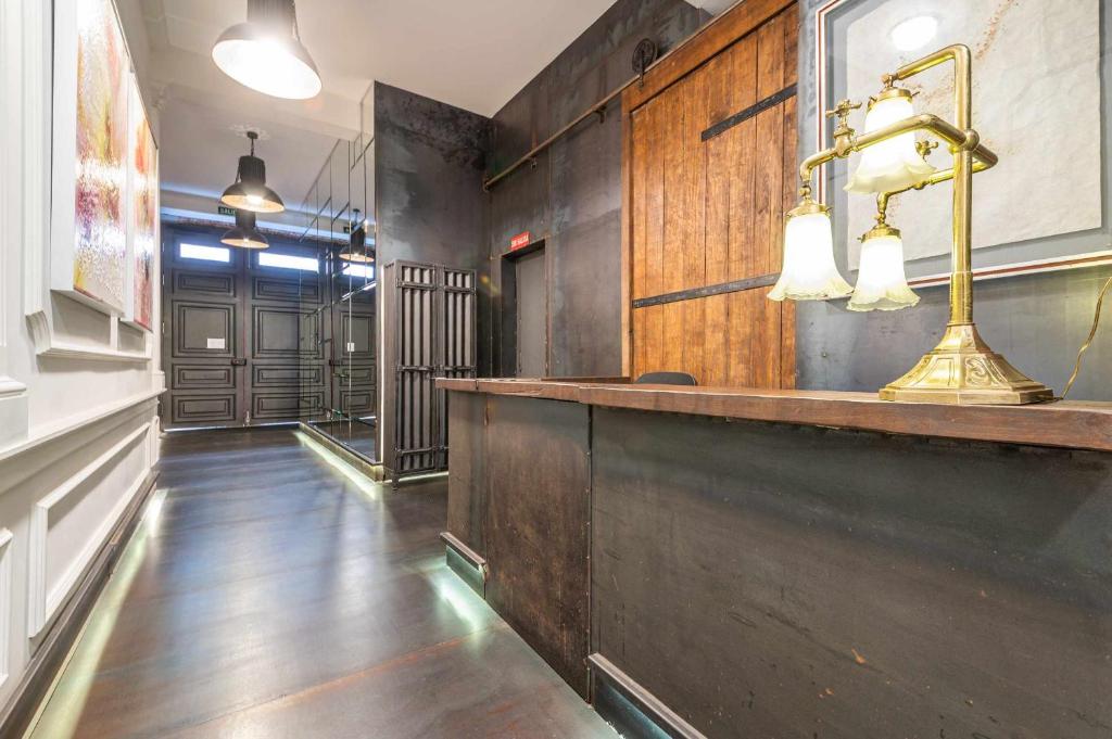a pub with a bar with a desk and lights at Apartamentos Libertad 24 in Madrid