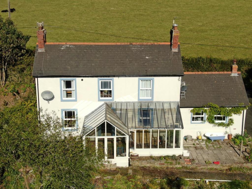 an aerial view of a large white house with windows at Cherry Grove Welsh Farmhouse in Pembrokeshire